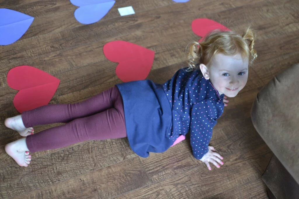 Check out this Valentine game that incorporates gross motor skills, color & letter identification, identifying right and left... and exercise. DIY Valentine Twister with a Twist. Fit mom, Hollie loves to keep her kids fit and active too!