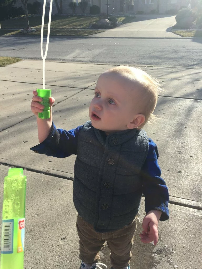 A little boy, his bubbles and the look of wonder. 